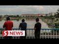 Govt breaking down river embankment to free stagnant floodwater in Taman Sri Muda