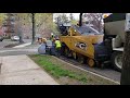 Cat tractor and asphalt trailer with a cat paver close up view