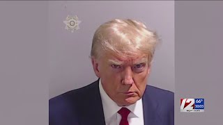 Mug shot of Donald Trump during speedy booking at Atlanta jail shows scowling former president