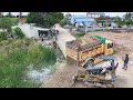 Full processing filling up the land huge bulldozer mitsubishi bd2f dump truck unloading