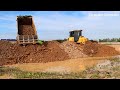 Epic 7 good team working dump truck dumping soil stone back fill and dozer moving in to water