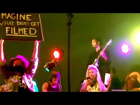 Musician Plays Guitar on the Back of Pickup Truck During Protest