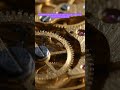 STOCHASTIC WEAR: A mechanical clock’s brass gears slowly losing precision to microscopic dust.
