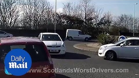 Shocking moment elderly man drives wrong way around roundabout - Daily Mail