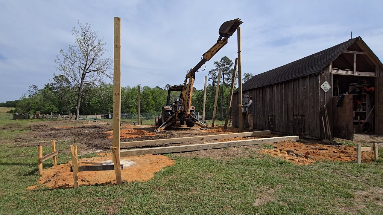 Installing 20-foot Posts with a 555D Backhoe - YouTube