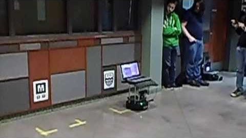 TurtleBot docking in front of a logo