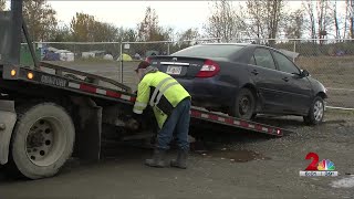 Tow trucks at downtown Anchorage homeless camp