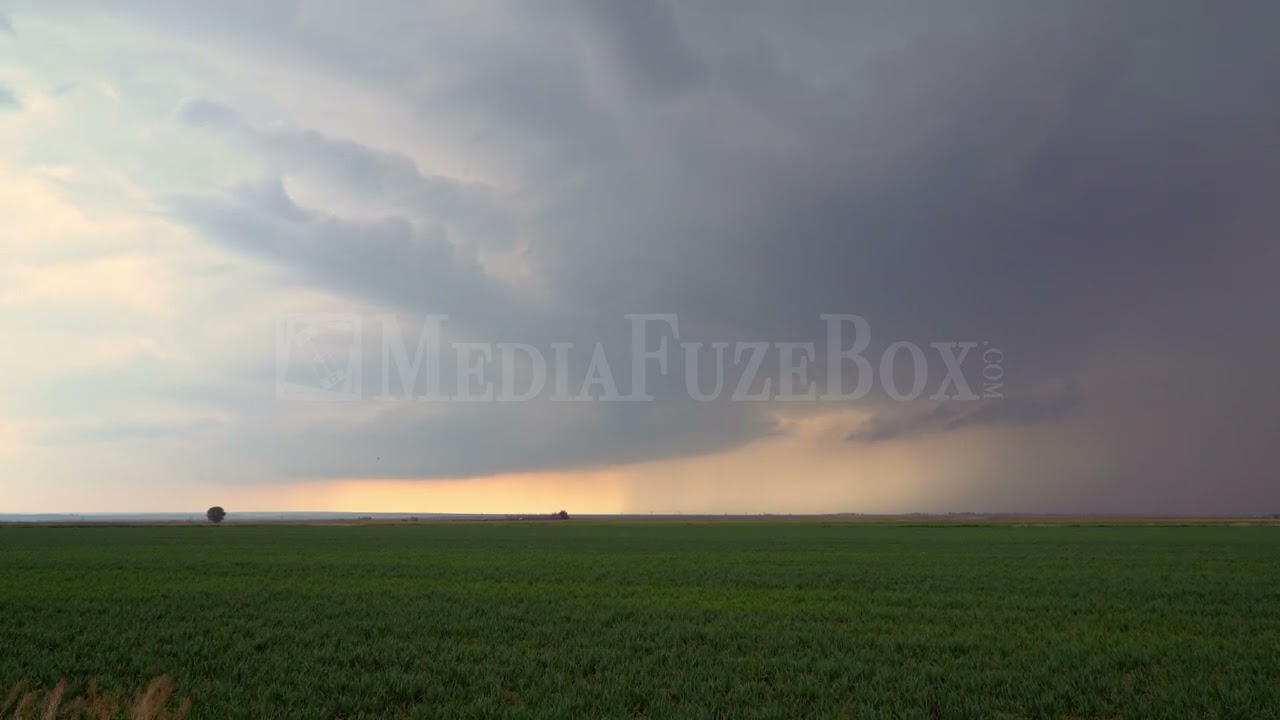 Stock Video - Storm moving through the plains in Colorado moving across green fields