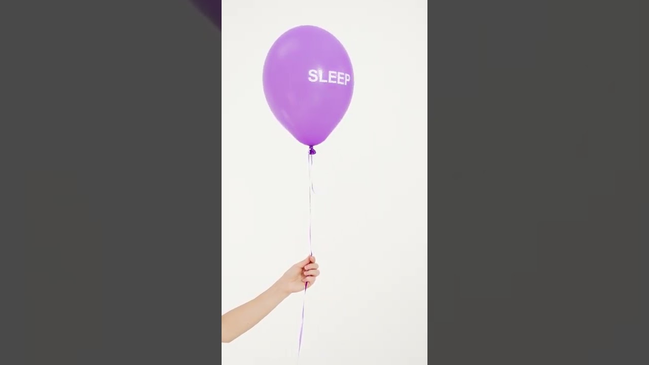 person holding a purple balloon