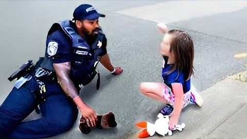 Police officer comforts little girl after she asks 