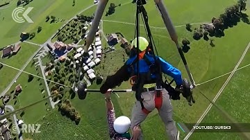 Tourist hangs on for his life after hang glider pilot forgets to secure him