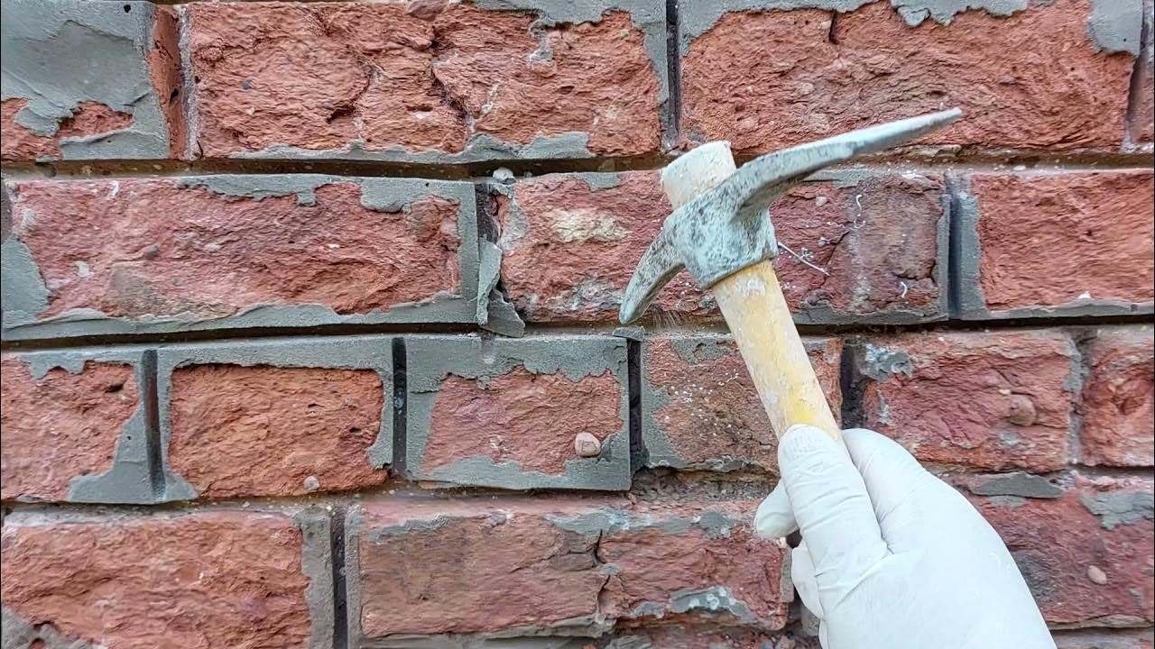 removing hard cement from a 150 year old house with handmade bricks to