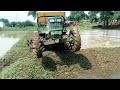 John Deere 5055e four wheel drive tractor stuck in mud puddling time rice framing