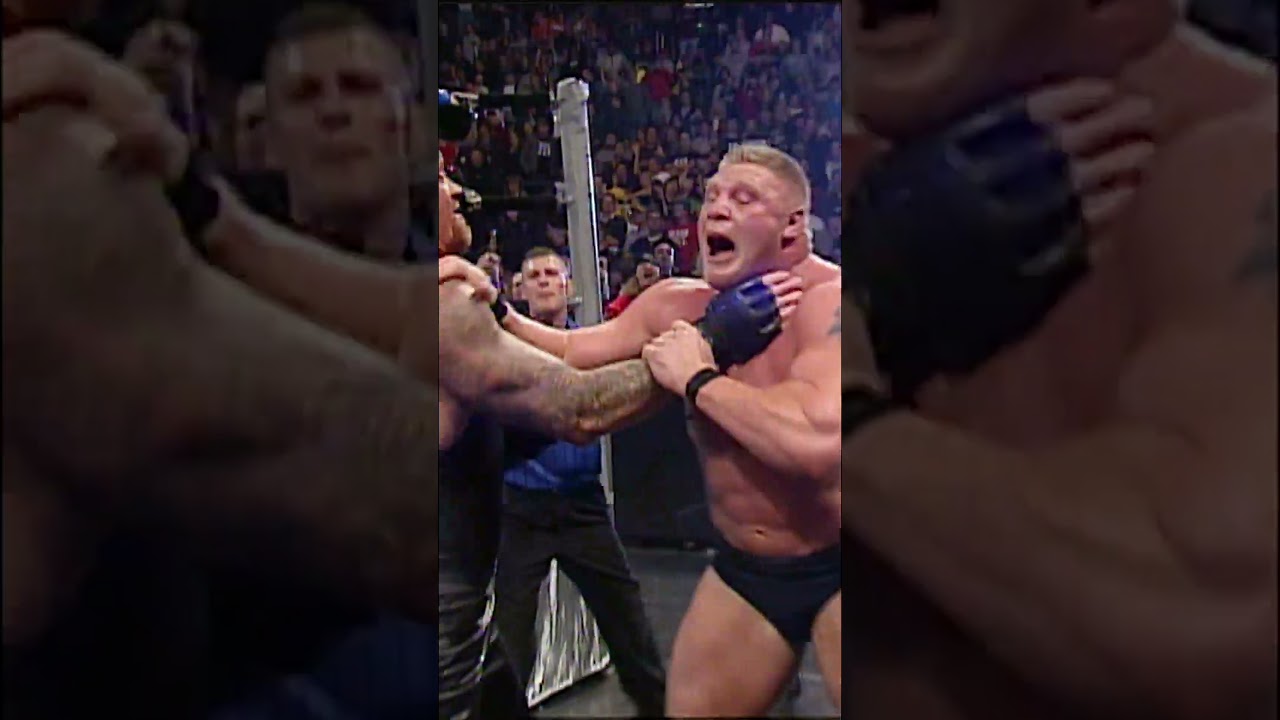 Undertaker nearly breaks Brock Lesnar in half with a menacing Chokeslam through the announce table.
