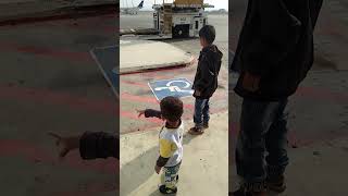 My Boys on Runway of Jeddah Airport with the Planes around before entering into Plane to Pakistan