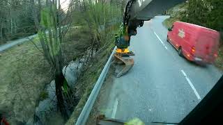 Volvo EWR150E  clears dirt beneath crash barriers so water can run off the road