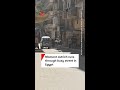 Moment ostrich runs through busy street in Egypt