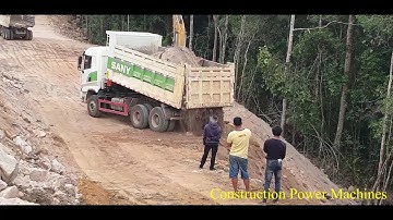 Dump Truck unloading and Excavator Cat 320 working  Spreading soil