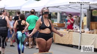 Why did this woman strip in public?