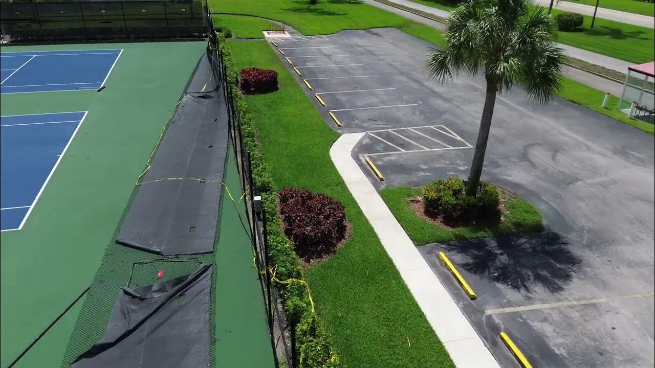 early-hurricane-season-storm-downs-tennis-court-fence-in-century