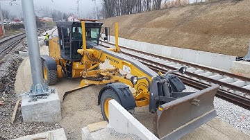 Motor Grader Grading In Tight Corners On The Railroad Station-Skilled Operator