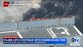 Local emergency declared as Boyle Heights warehouse fire flare-ups persist, smoke drifts beyond area