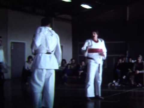 Old school Taekwondo competition in Adelaide, South Australia, probably around late 70's, early 80's.  Compare to today's modern sport TKD, a lot more raw, more variety of technique, no arm/shin/foot/mouth guards.  No head punches even then, so there's still that awful close hold, but a lot more interesting IMO than today's sterile points leg flicking.  This is a Colin Handley, a student of Grand Master Lee in the red. I'm not sure who his opponent is, but it looks like a local competition.  Transferred from old super 8 film. No sound unfortunately!