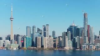 Airplane landing at Toronto airport, skyline revealing CN Tower and iconic landmarks while