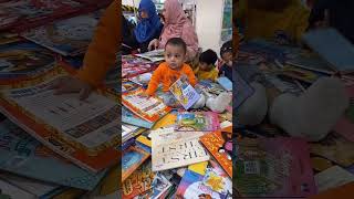 Cute Book lover at our stand in Karachi International Book Fair.#booklover #cute #children #reading