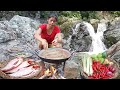 Adventure in forest catch red fish at waterfall nature  red fish soup for food of survival