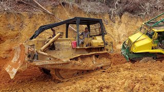 BULLDOZER PULLED OUT TIMBER TRUCK STUCK IN MUDDY ROAD.