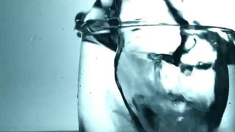 Ice cube fall into cup of water super slow motion - free stock footage
