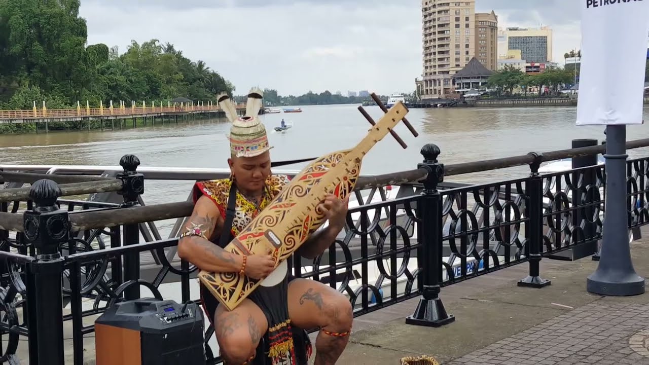 Playing a Sape', a guitar like instrument by native of Borneo musician.