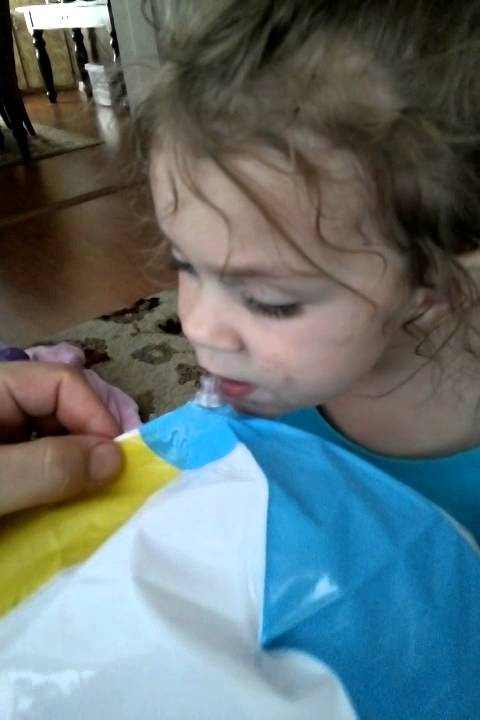Prestynn trying to blow up a beach ball