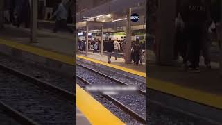 Toronto commuters seen crossing train tracks at Union Station