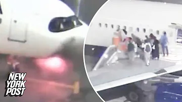 Wild video captures moment fireball explodes on Delta jet as passengers evacuate on emergency slides