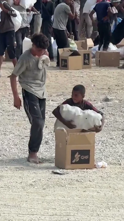 Young boy collecting aid in Gaza during hunger crisis