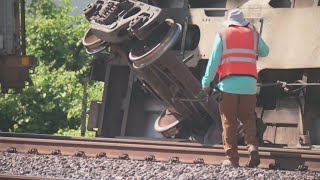 Nearly a dozen rail cars tip over on overpass in northwest Houston