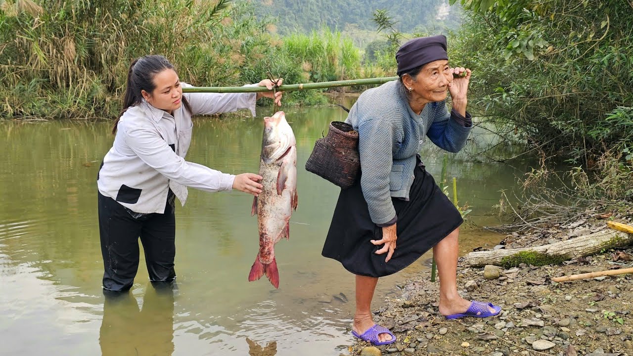The homeless girl was delighted to see the old woman catch a large fish in the river.