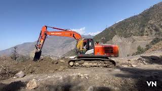 Tatab Hitachi machine and dumper clearing the road after heavy rainfall 1710683909774043