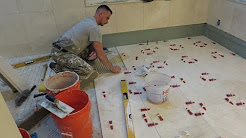 "1" Installing 18x18 Travertin stone tiles on bathroom floor with T-Lock leveling system