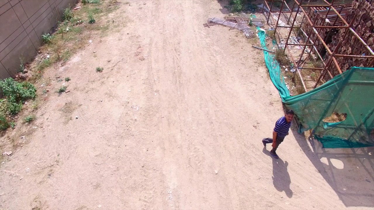 Aerial Stock Footage india Drone fascinates and then follows a random man DJI phantom quad 4