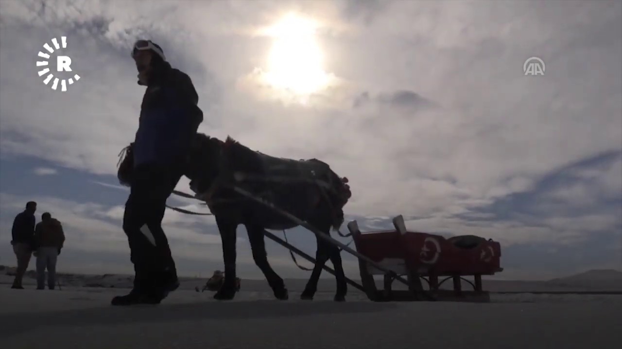 Winter tourists sled on frozen over Cildir lake in the Kurdish province