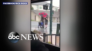 Boy helps elderly man cross the street during hailstorm in act of kindness