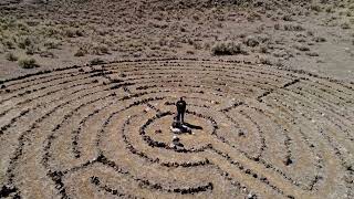 Stock Video - Person standing in the middle of a labyrinth flying overhead to view the pattern