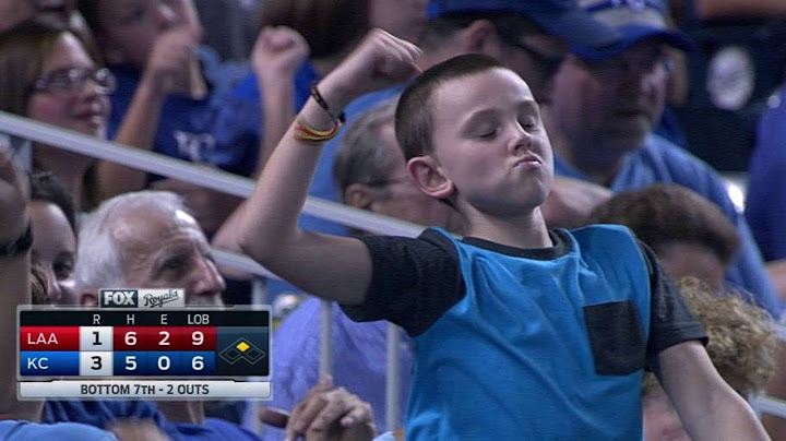 A young fan dances during a pitching change