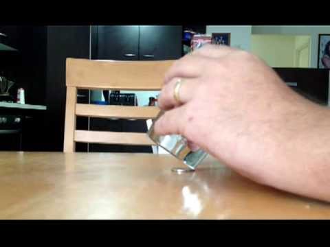 Balancing Glass Of Water On A Coin Edge