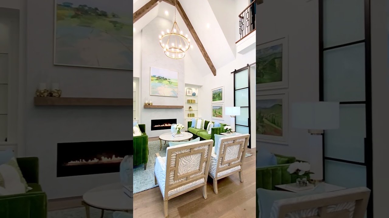 Living Room with Blue and Green Accent Colors, a Vaulted Ceiling and Fireplace - Model Home