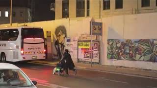Orhodox jew running for the bus with baby stroller in Jerusalem