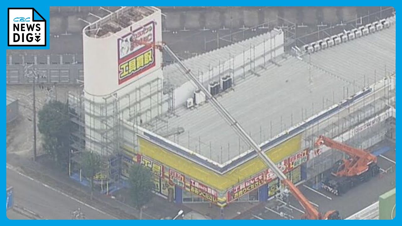 Stabs into a sign A crane falls and smashes into a store sign